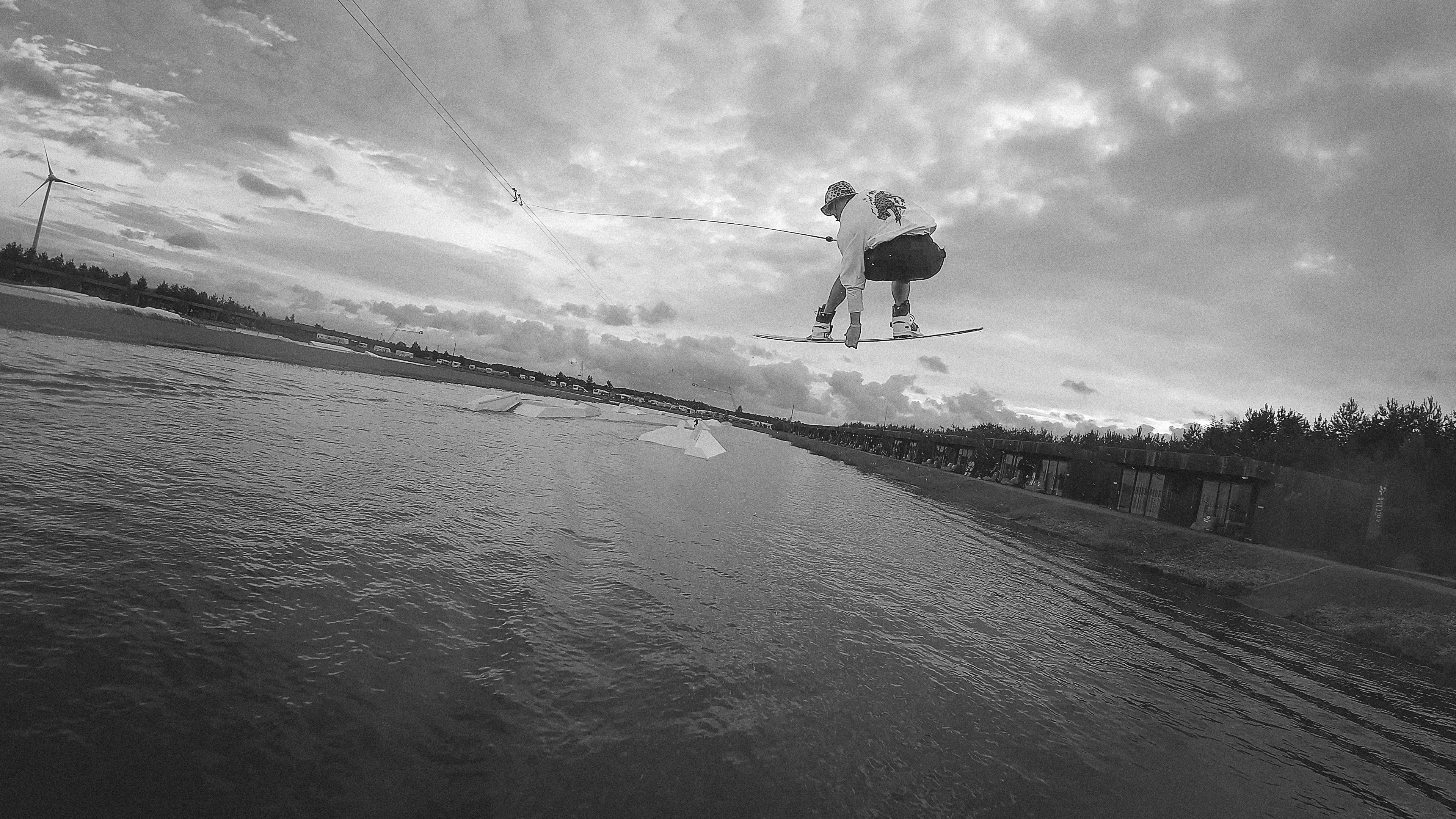 The rider mid-session, spray tearing off the edge of the board.