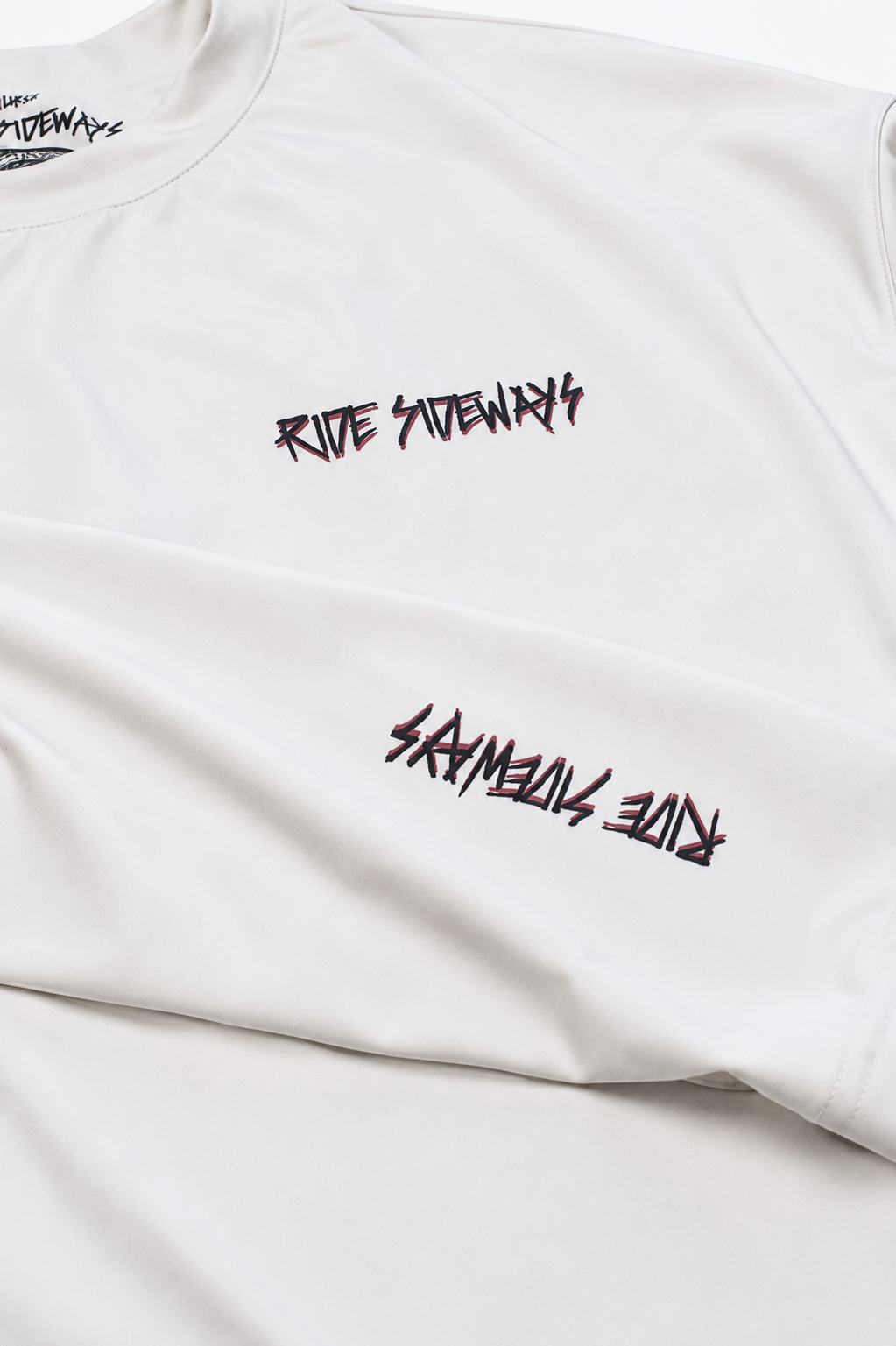 Close on the small black logo marks on white fabric.
